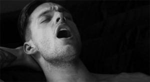 Black and white photo of a man climaxing