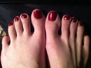 Pedicured feet with red nails