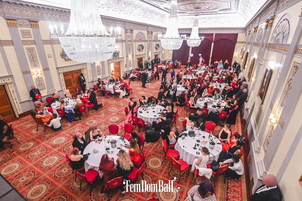 Bondara Sex Toy Blog - We Went to the FemDom Ball 2023 - Overhead shot of the hall filled with FemDoms in their finery with subs on leashes